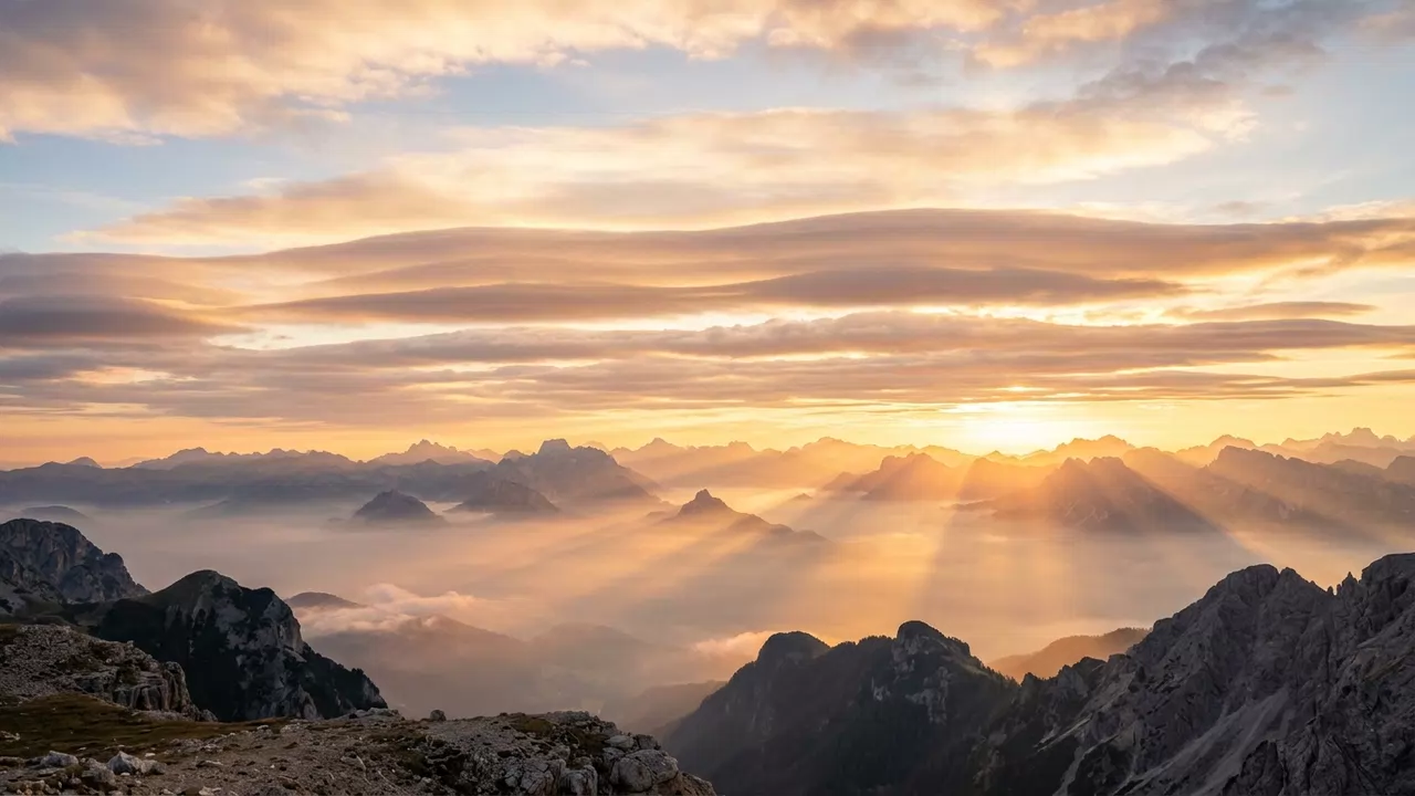 Golden morning sunlight breaking through serene clouds above mountains, symbolizing celestial orders and heavenly peace